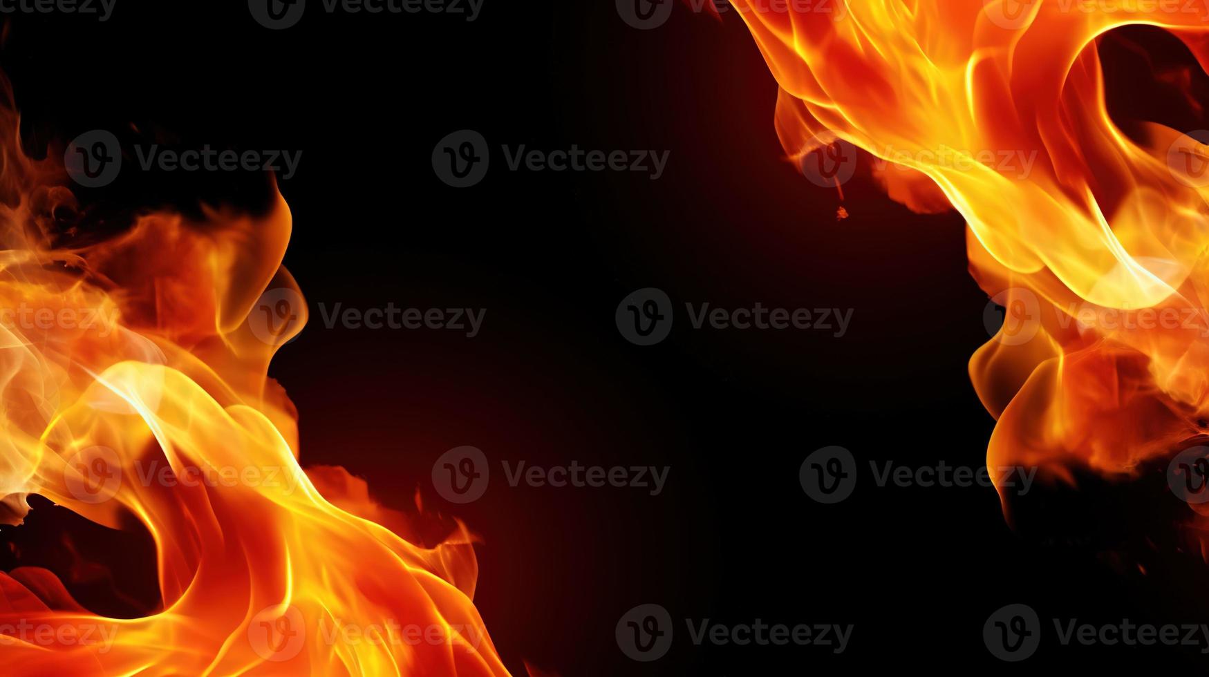 Fire flames on black background. Closeup of fire flames isolated on black background. photo