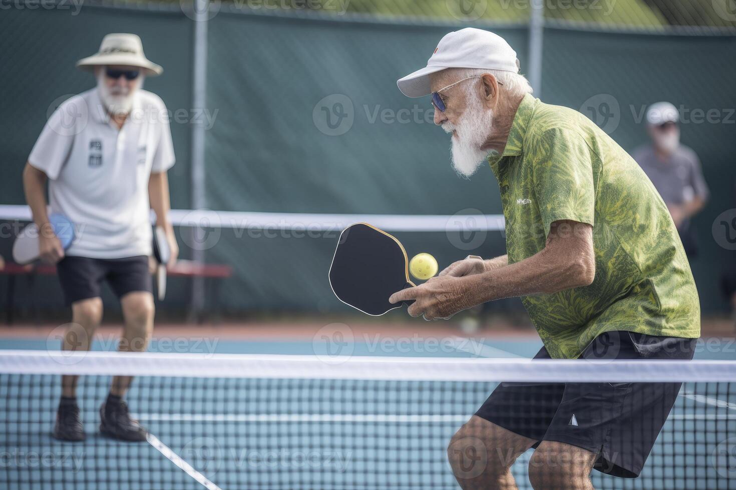 Photo of an elderly man holding a pickleball racket on a pickleball court.