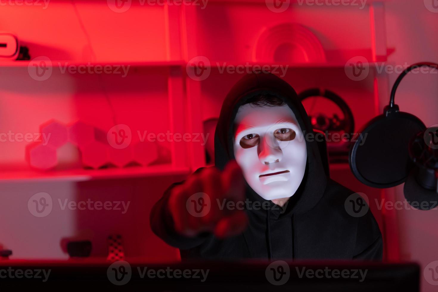 This is the face of a hacker who is knowledgeable with operating systems and other programs. He will exploit flaws and breach the computer system to cause damage. photo