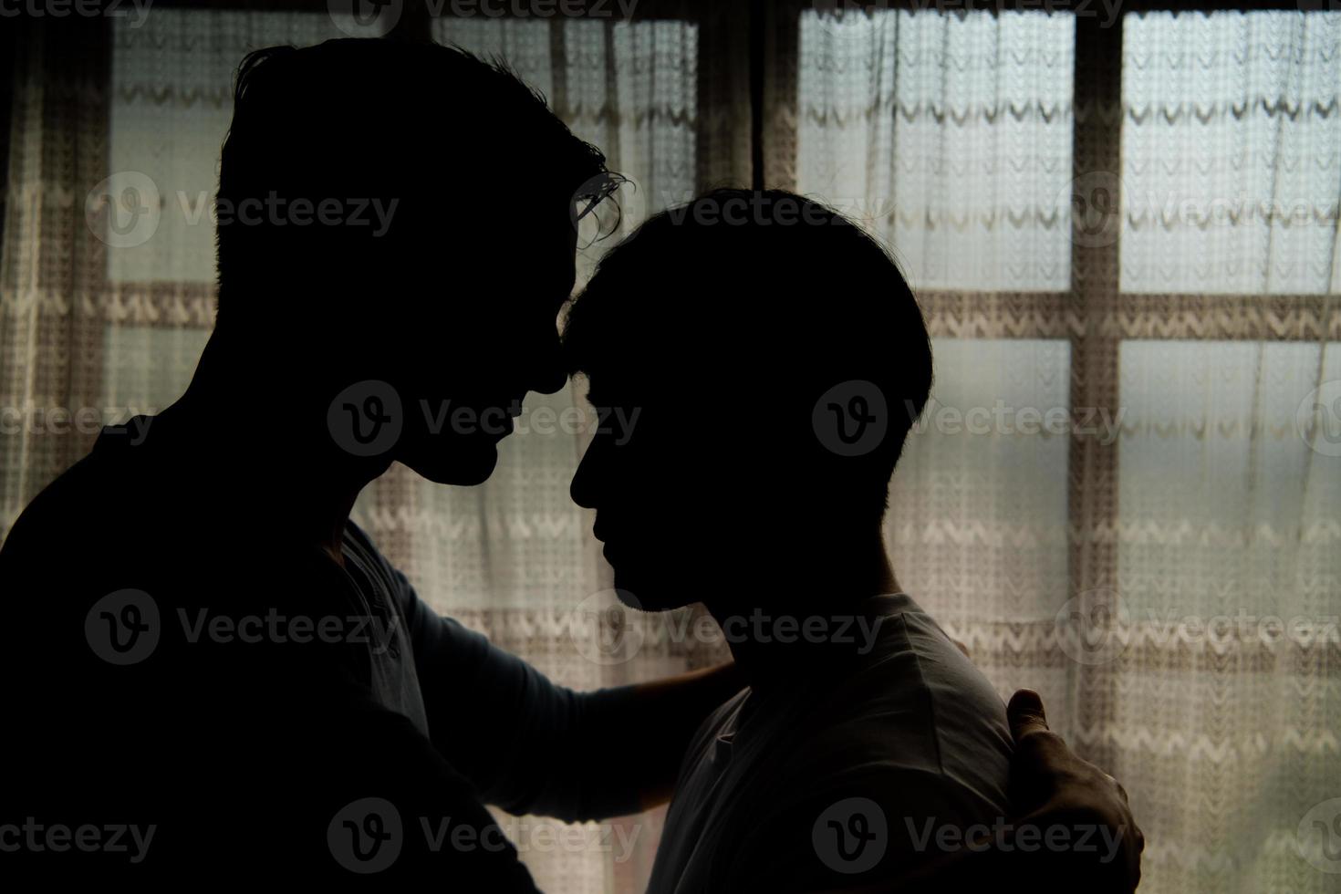 The shadow reflection of an LGBT couple in their private bedroom with a loving vibe between them. photo