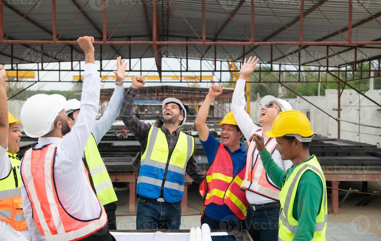 Construction engineers, architects, and foremen form a group. Participate in a meeting to plan new construction projects. Cheers to express happiness that the event was successfully accomplished. photo