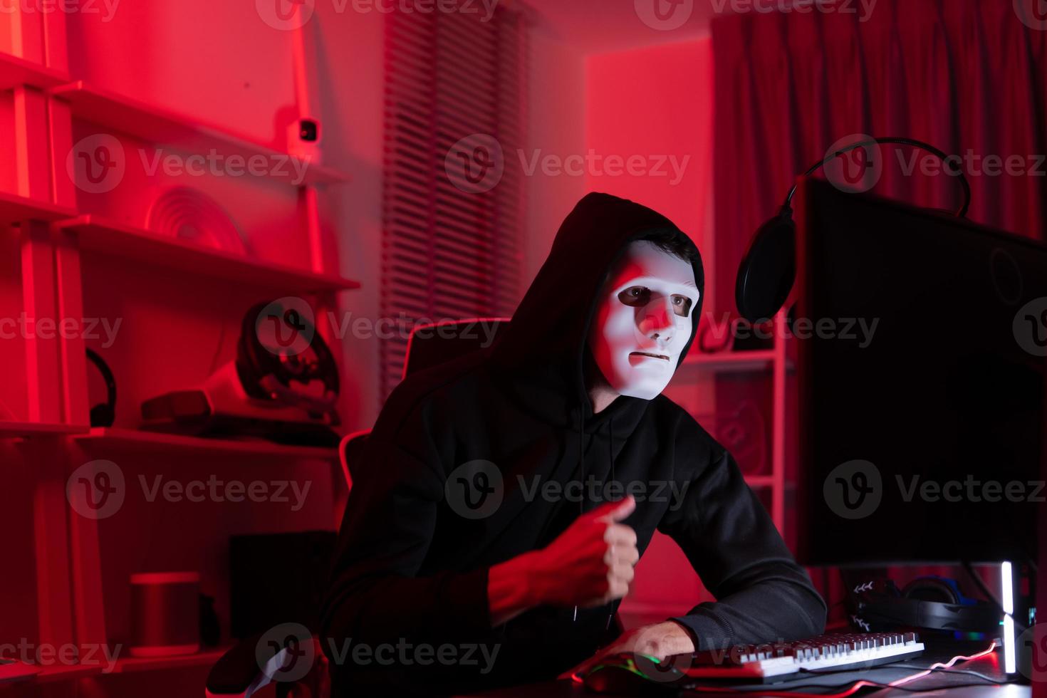 This is the face of a hacker who is knowledgeable with operating systems and other programs. He will exploit flaws and breach the computer system to cause damage. photo