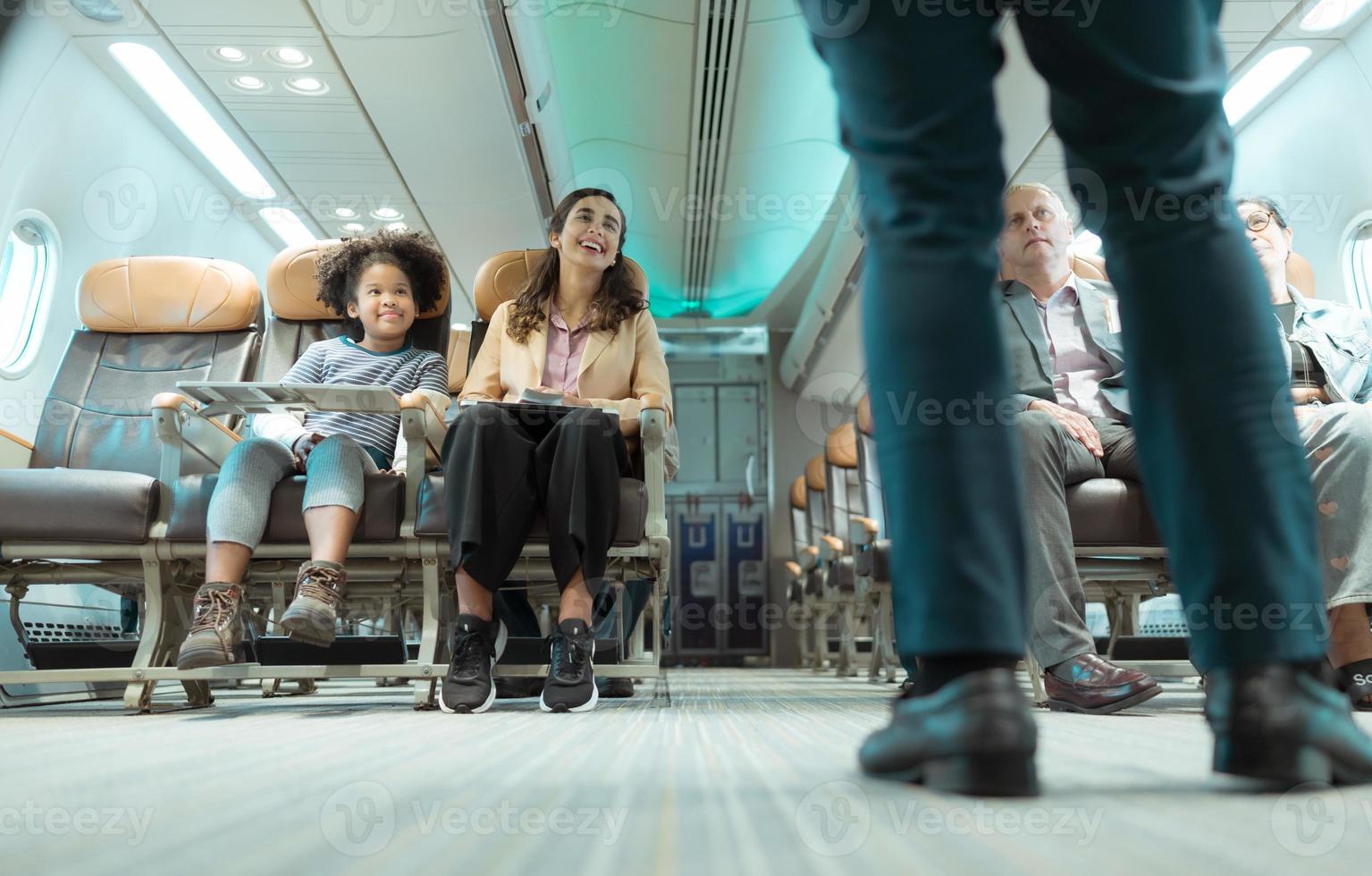 Flight attendants show how to use safety devices and recommend emergency exits. photo