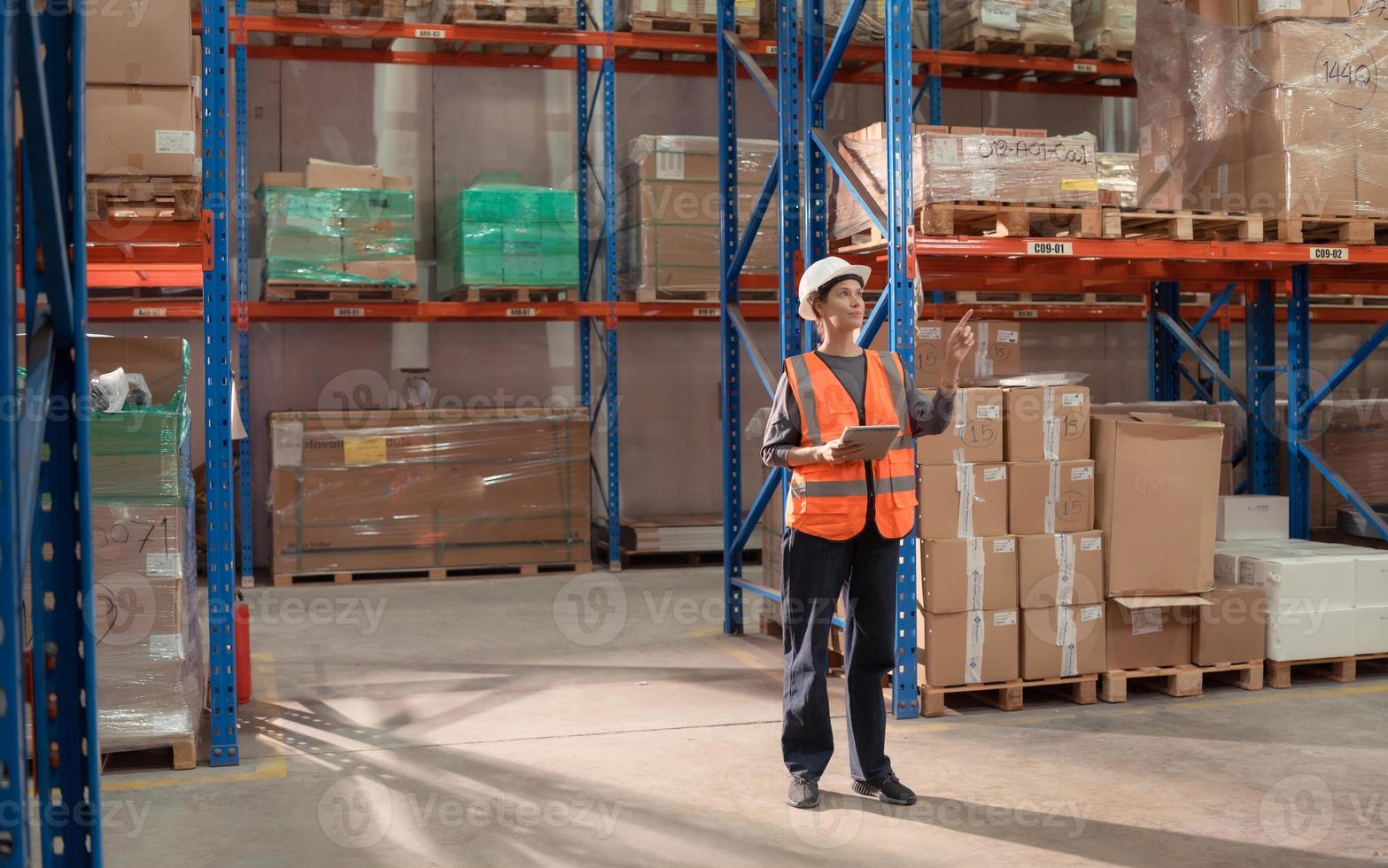 Portrait of warehouse supervisor in a large warehouse with their own preparation for the day's work photo