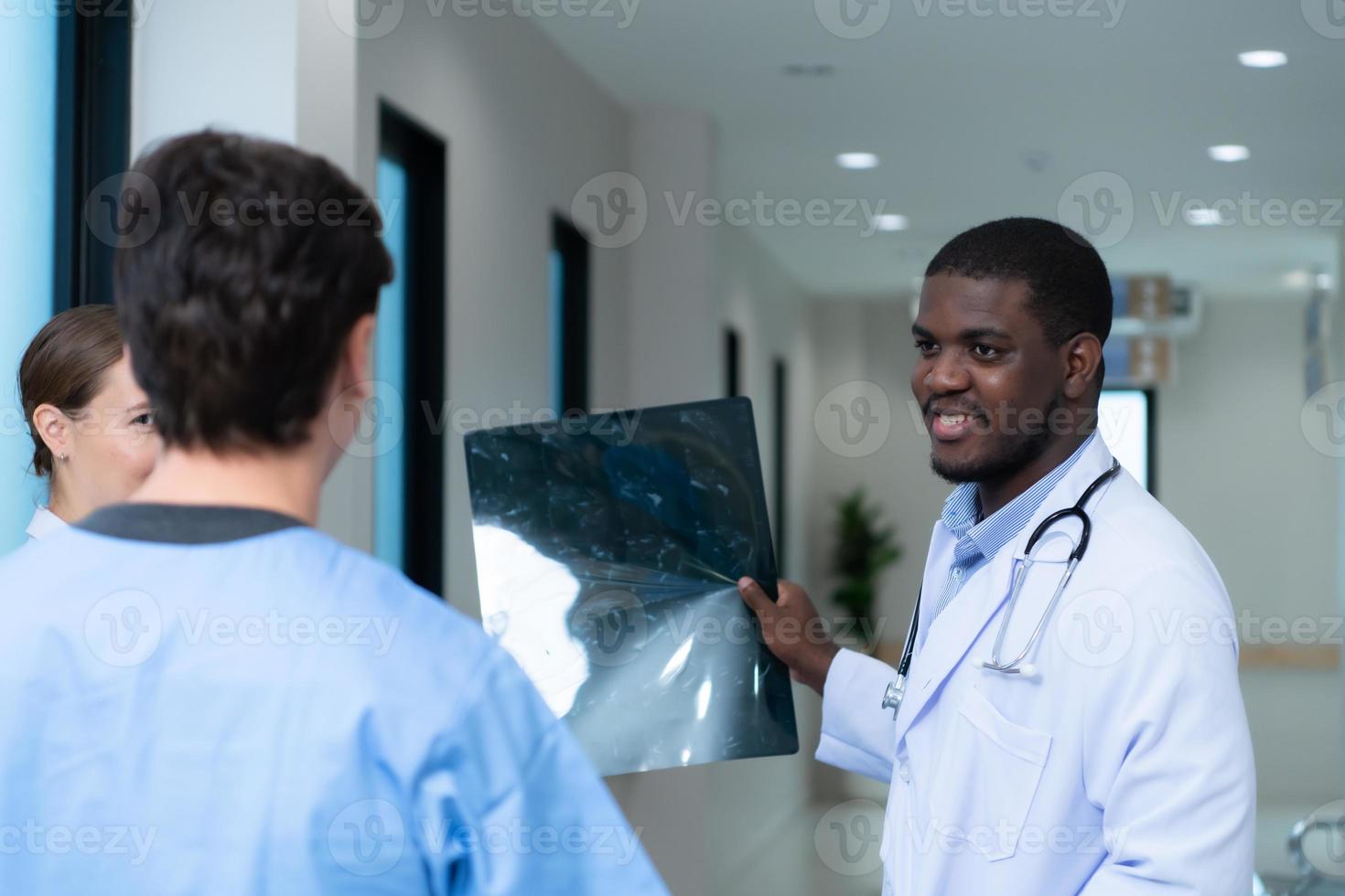 Medical teacher and interns see brain x-ray results of a patient who suffered a concussion after the accident. and inform the patient that the brain is normal photo