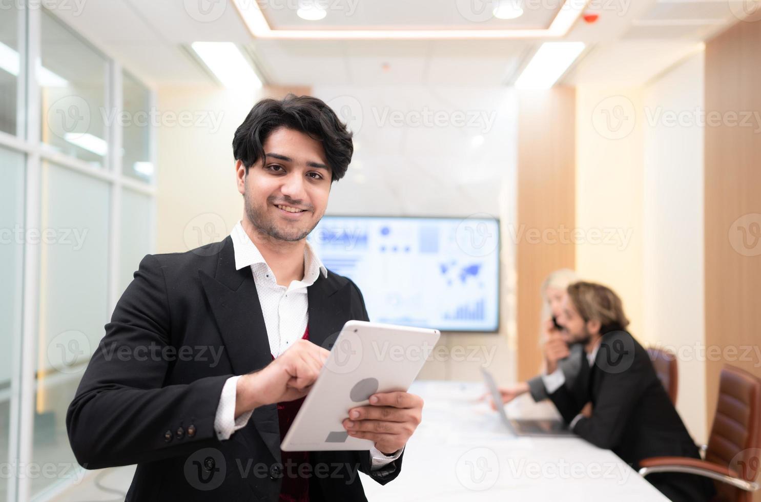 At the meeting room, a young businessman sitting in a secret meeting with many other businessmen the atmosphere is happy photo