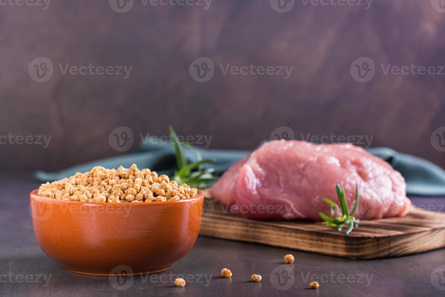 Choice between a bowl of soy meat and raw meat on the table photo
