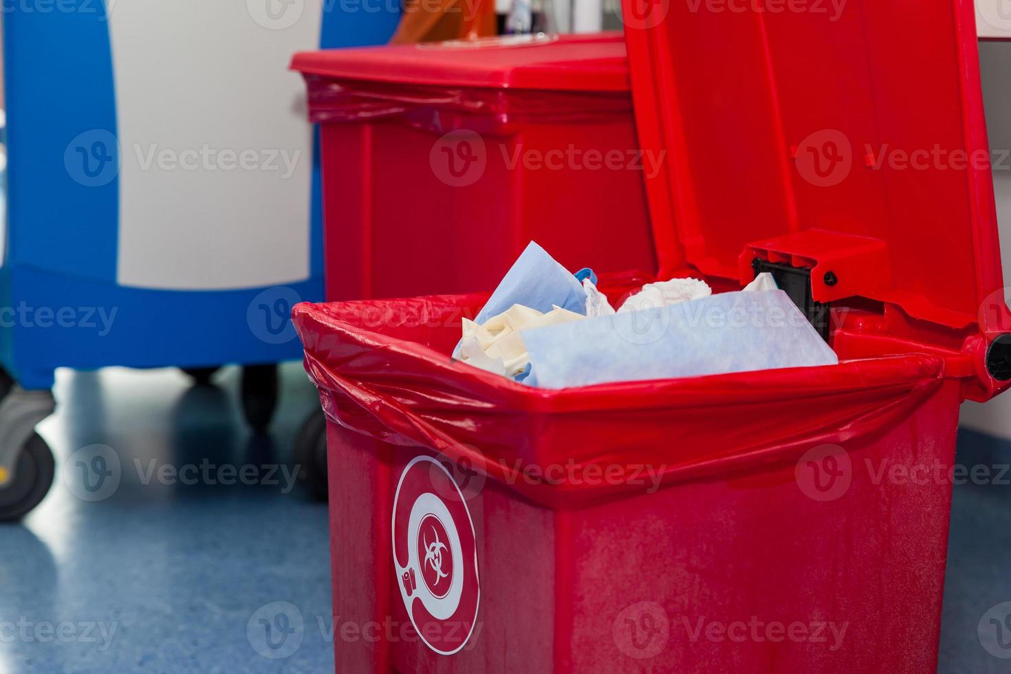Biological risk waste disposed of in the red trash bag at a operating room in a hospital. Sign showing the biological hazard symbol. photo