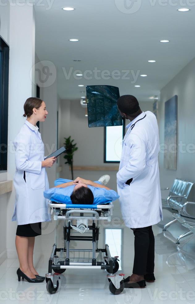 Medical teacher and interns see brain x-ray results of a patient who suffered a concussion after the accident. and inform the patient that the brain is normal photo
