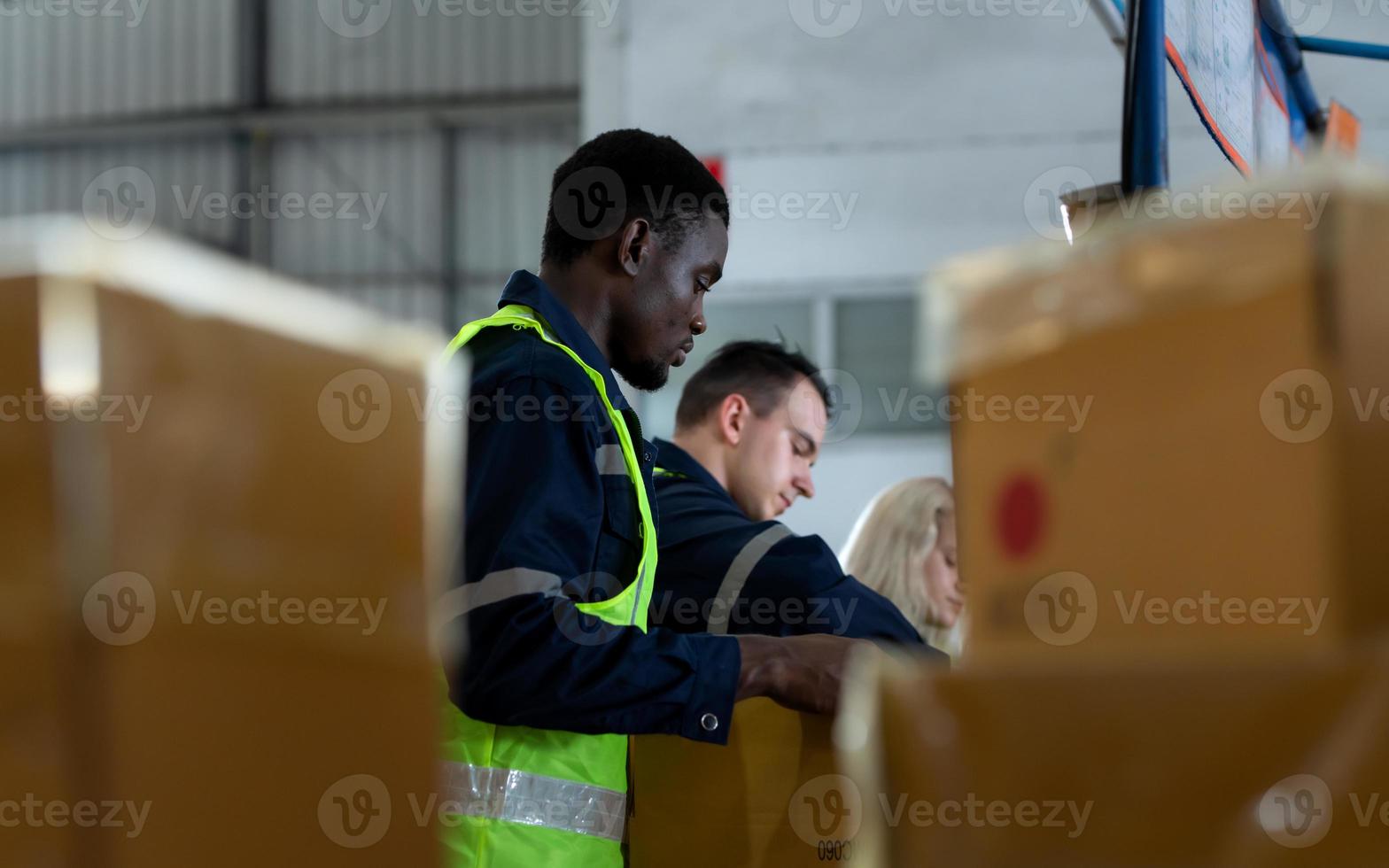 grupo de trabajador en auto partes almacén embalaje pequeño partes en cajas después inspeccionando el coche partes ese son Listo a ser expedido a el coche montaje planta. foto