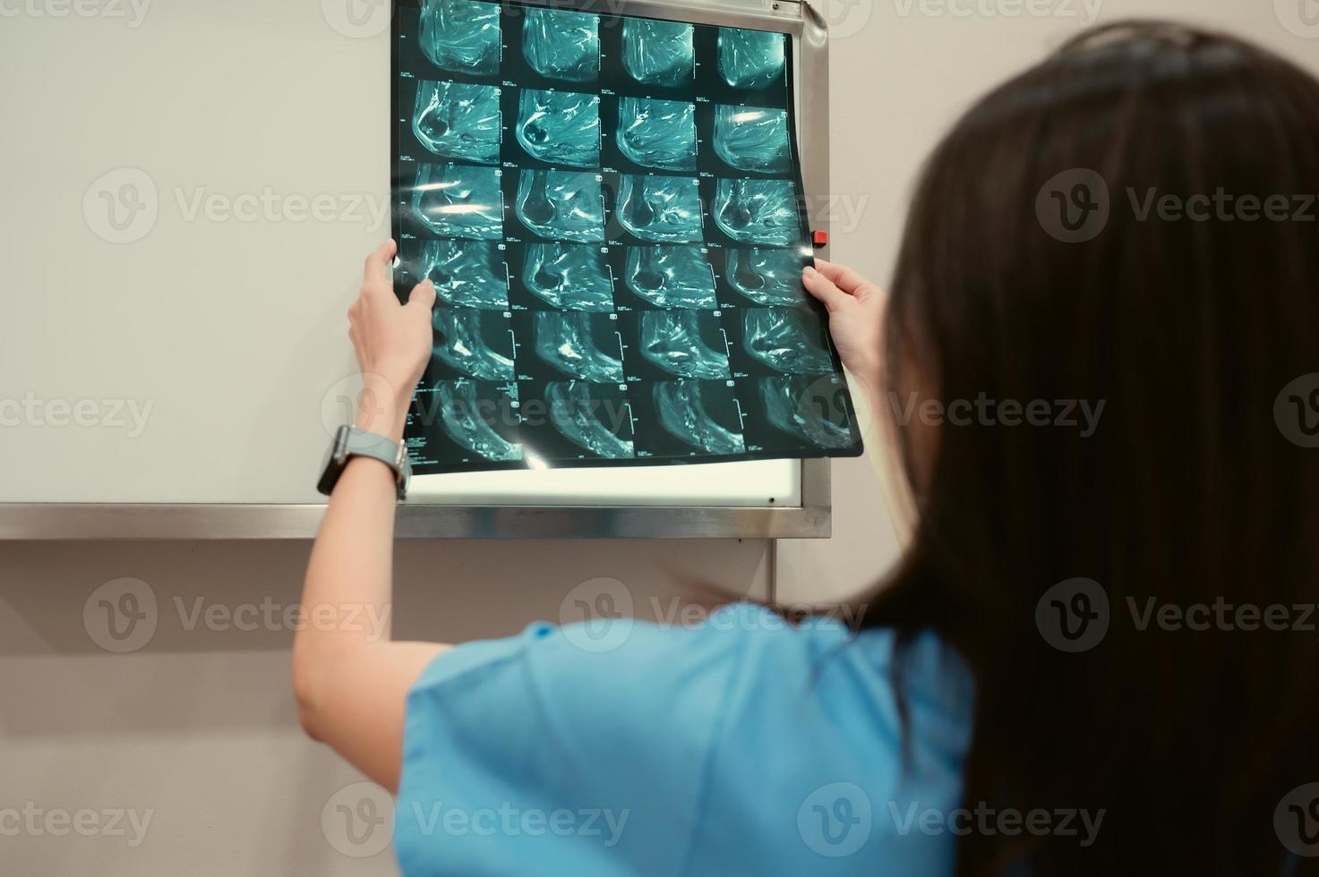 Doctor and patient's x-ray film in hospital examination room photo