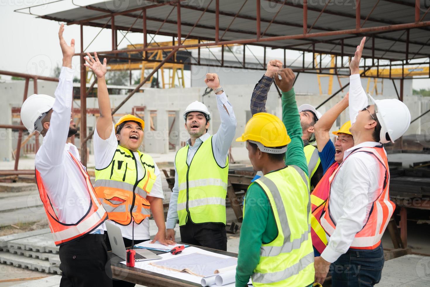 Construction engineers, architects, and foremen form a group. Participate in a meeting to plan new construction projects. Cheers to express happiness that the event was successfully accomplished. photo
