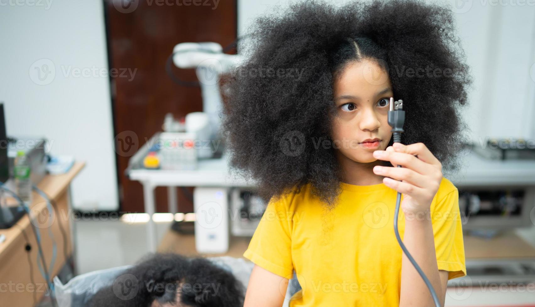Youngsters utilizing the hand robot technology are having fun learning the electronic circuit board of hand robot technology, which is one of the STEM courses. photo