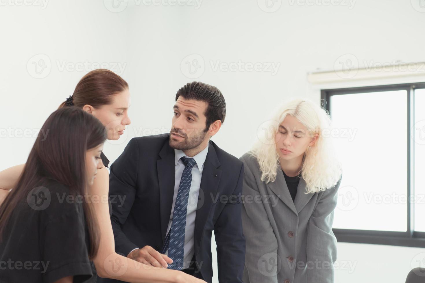 In the company meeting room Young executives are brainstorming ideas about a new business that will launch big soon. photo