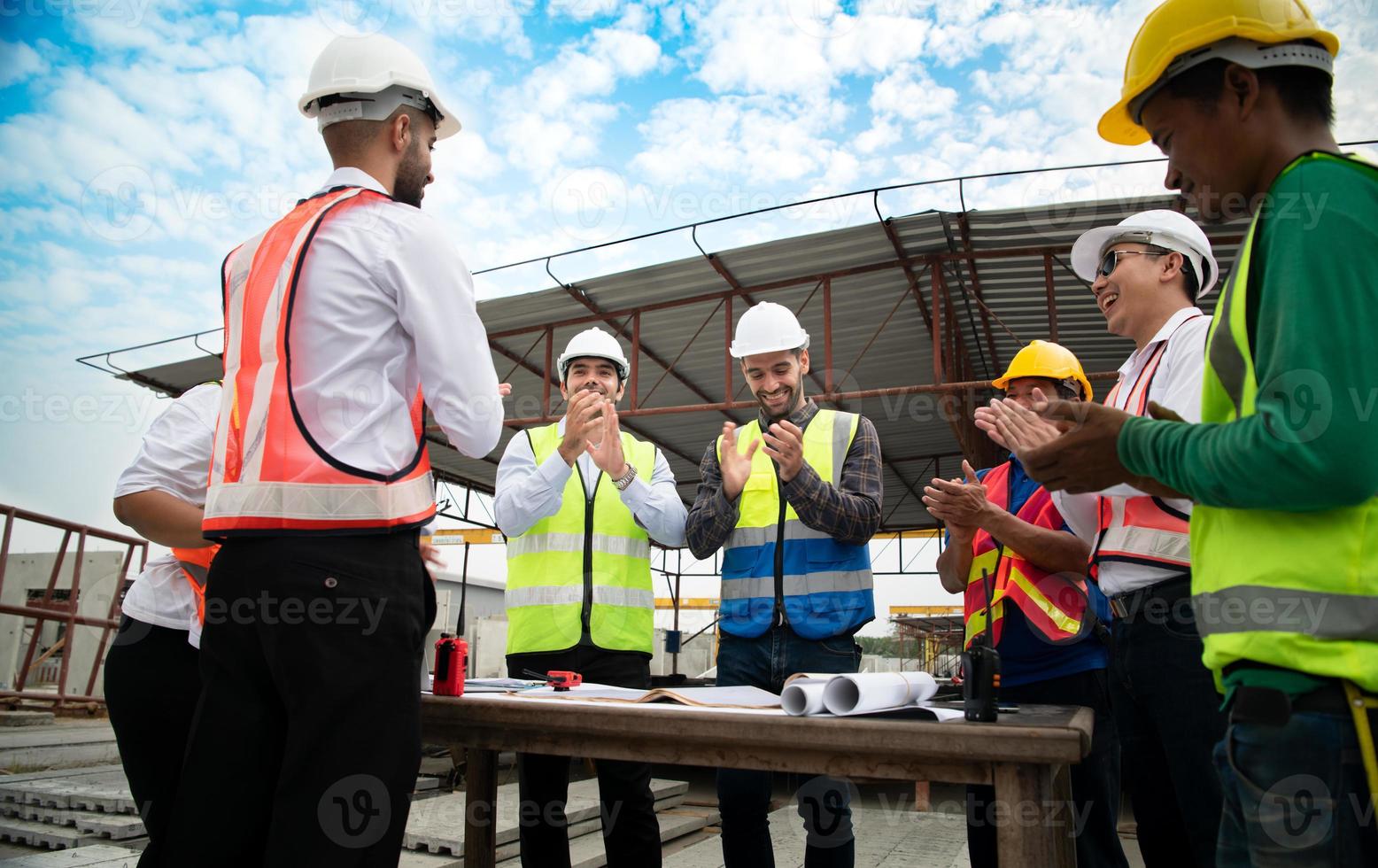 Construction engineers, architects, and foremen form a group. Participate in a meeting to plan new construction projects. Cheers to express happiness that the event was successfully accomplished. photo