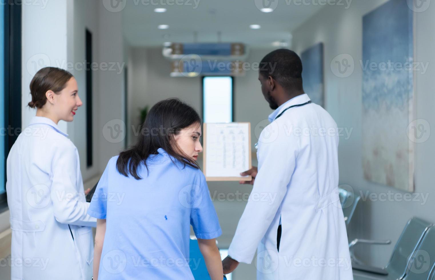 Medical professor and intern looking at an MRI of a patient who received a concussion to the head after an accident. and inform the patient that the brain is normal photo