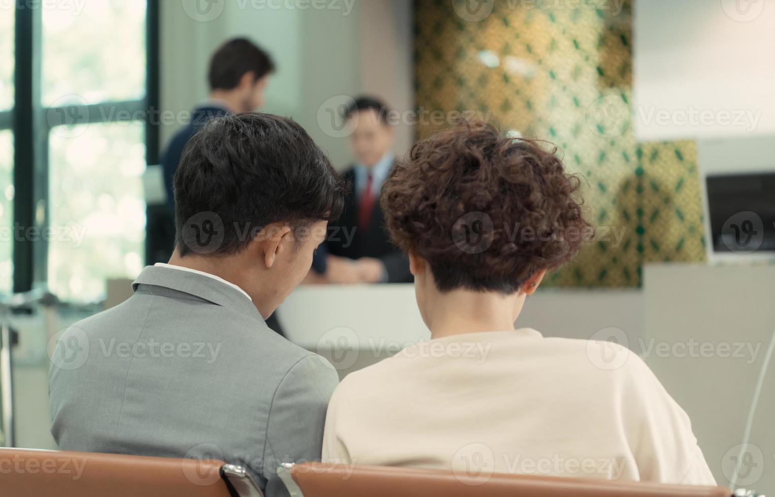 Passengers waiting to board the plane at the gate area photo