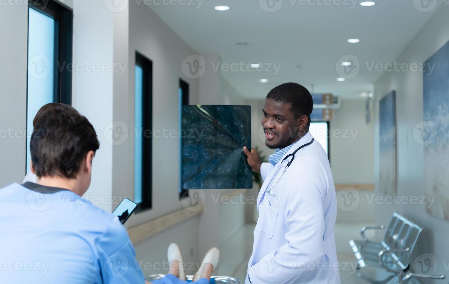 Medical teacher and interns see brain x-ray results of a patient who suffered a concussion after the accident. and inform the patient that the brain is normal photo