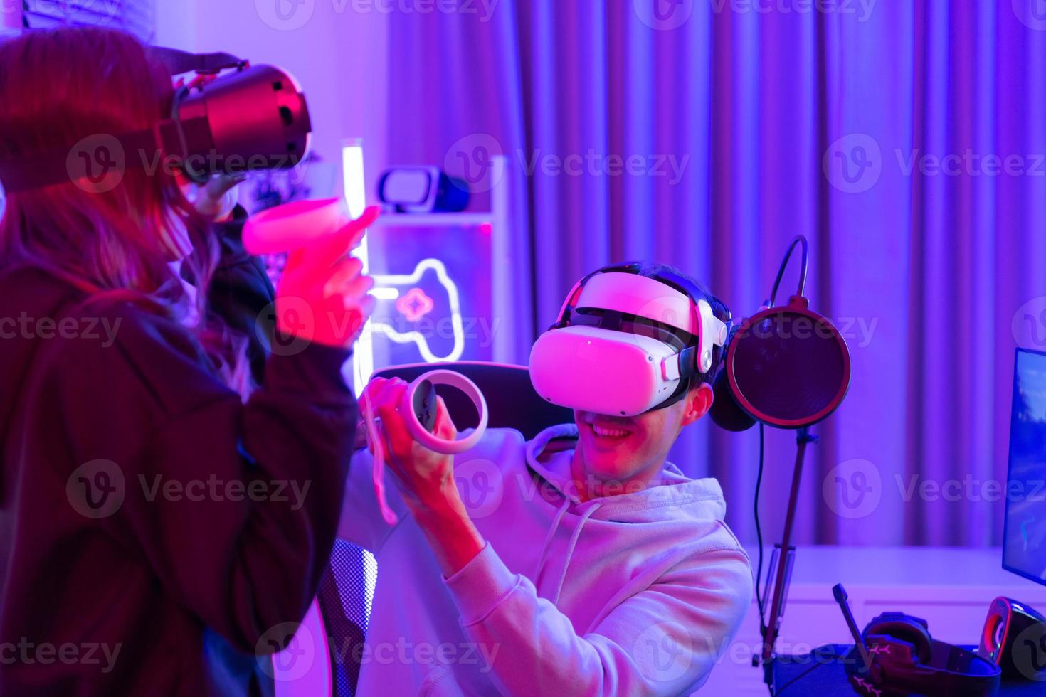 Two professional gamer playing games through VR machine that responds to very fun exciting and provocative photo