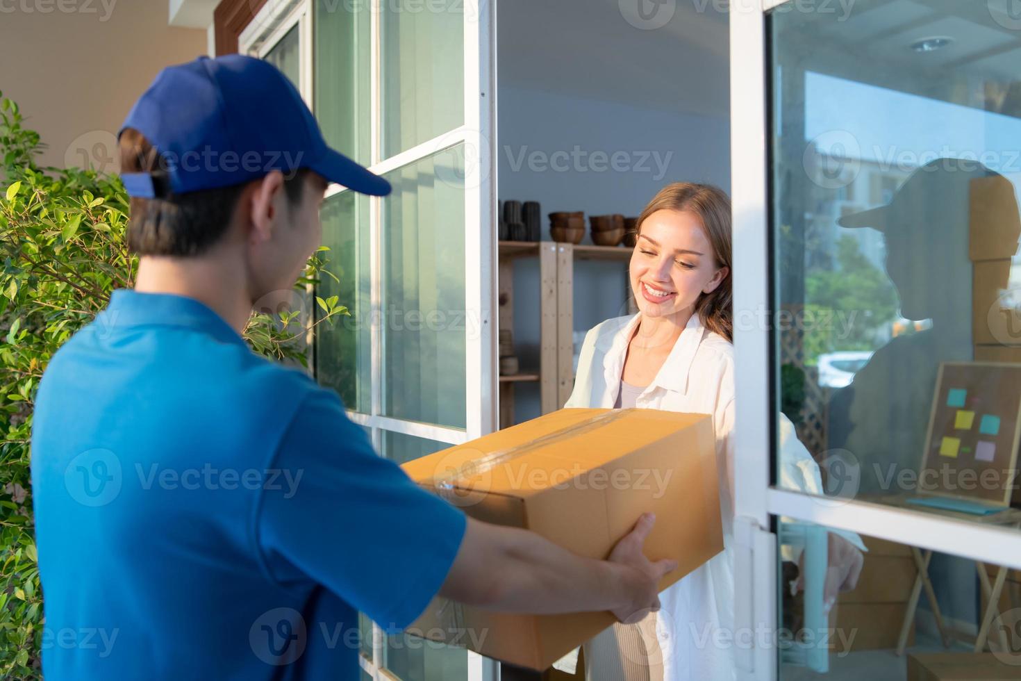 The delivery man brings the goods that the customer purchased and delivers them to the customer's home. photo