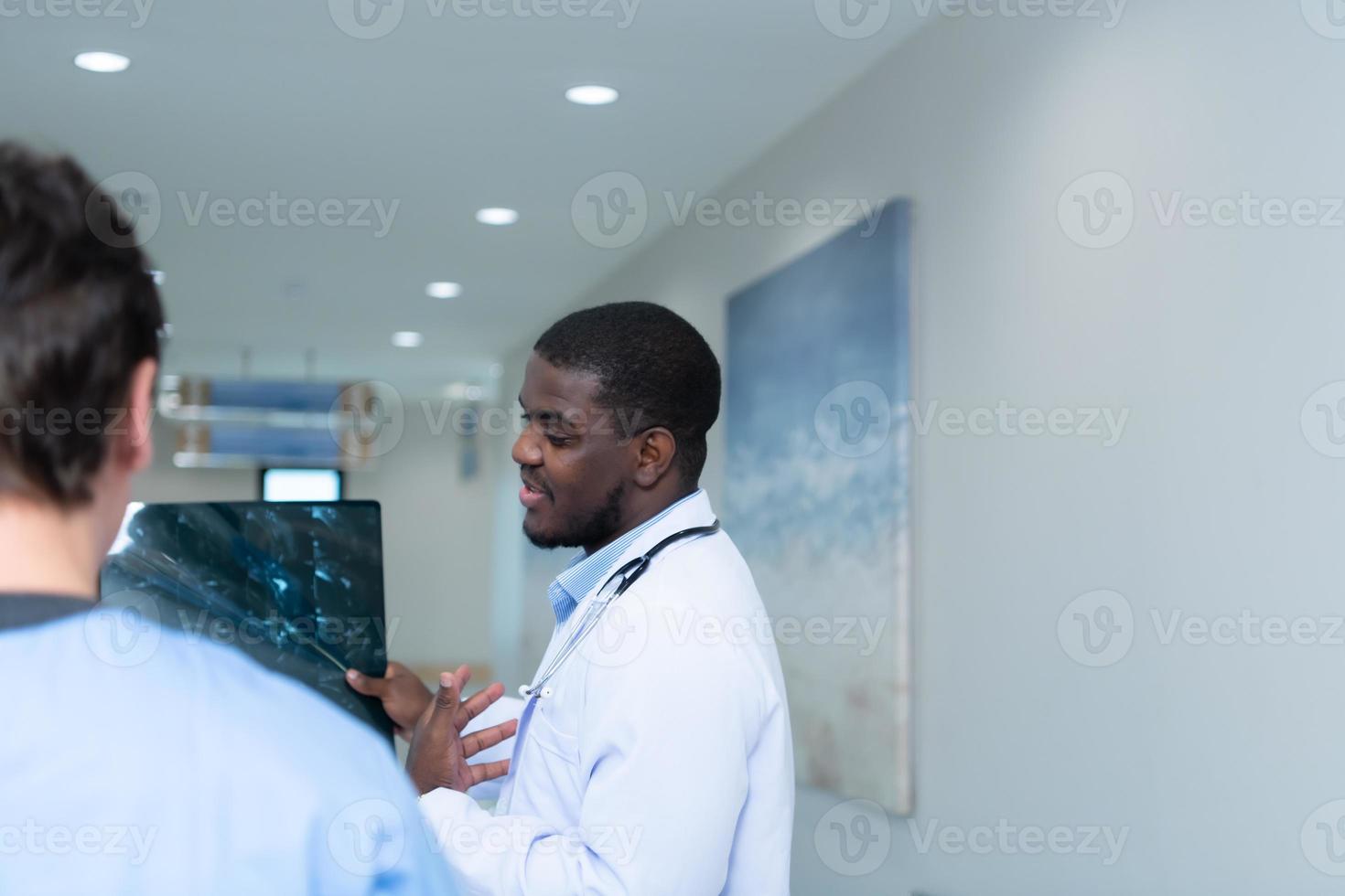 Medical teacher and interns see brain x-ray results of a patient who suffered a concussion after the accident. and inform the patient that the brain is normal photo