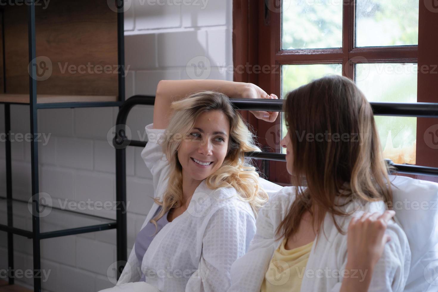 LGBT Young couple in the bedroom waking up in the morning sun with a cheerful mood. photo