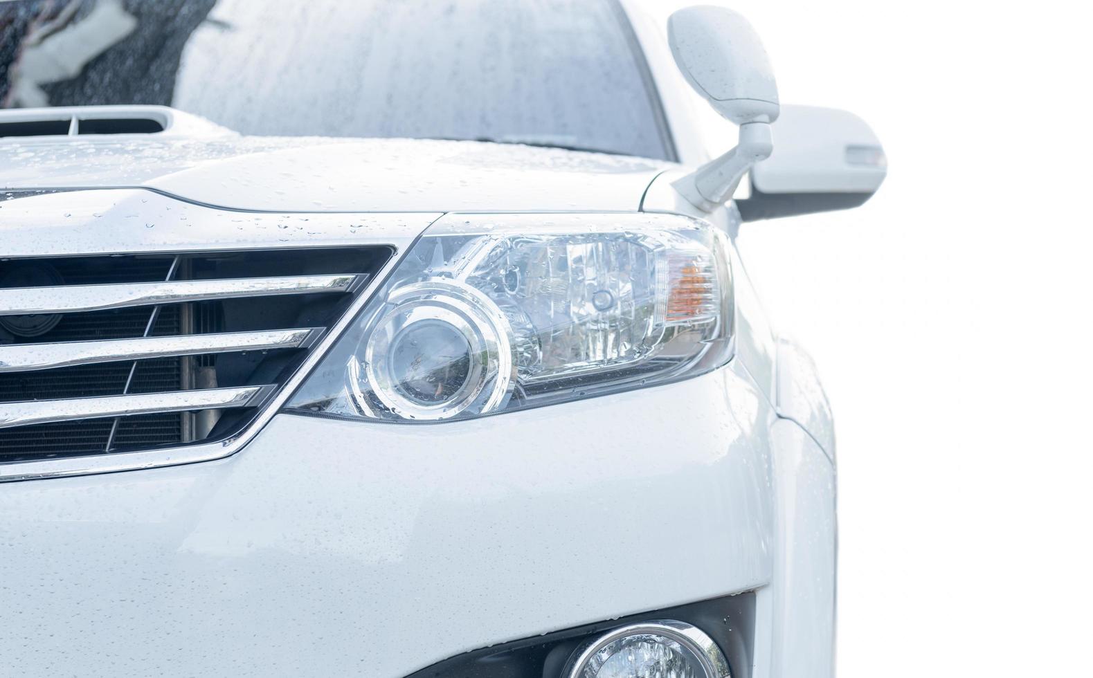 Projector headlight of white suv car photo