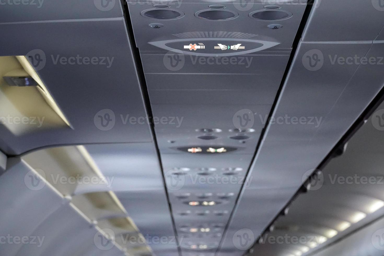Fasten Seat Belt and No Smoking Sign inside an Airplane photo