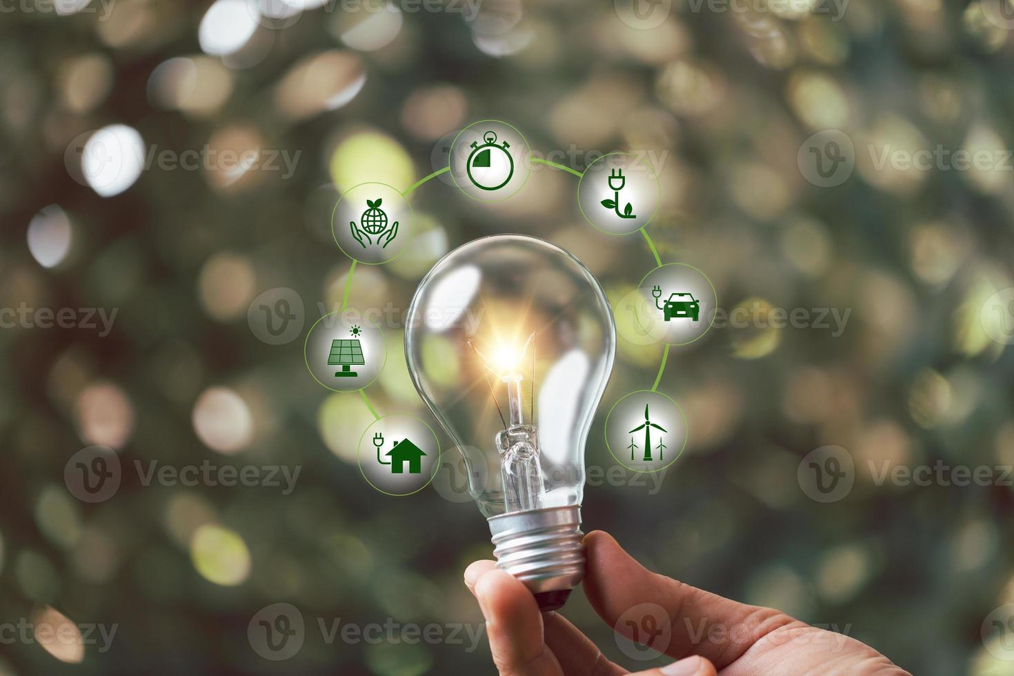 Saving sustainability energy concept, alternative energy, renewable energy power, electricity light lamp from solar on green natural background, World Caring Day, world environment day. photo
