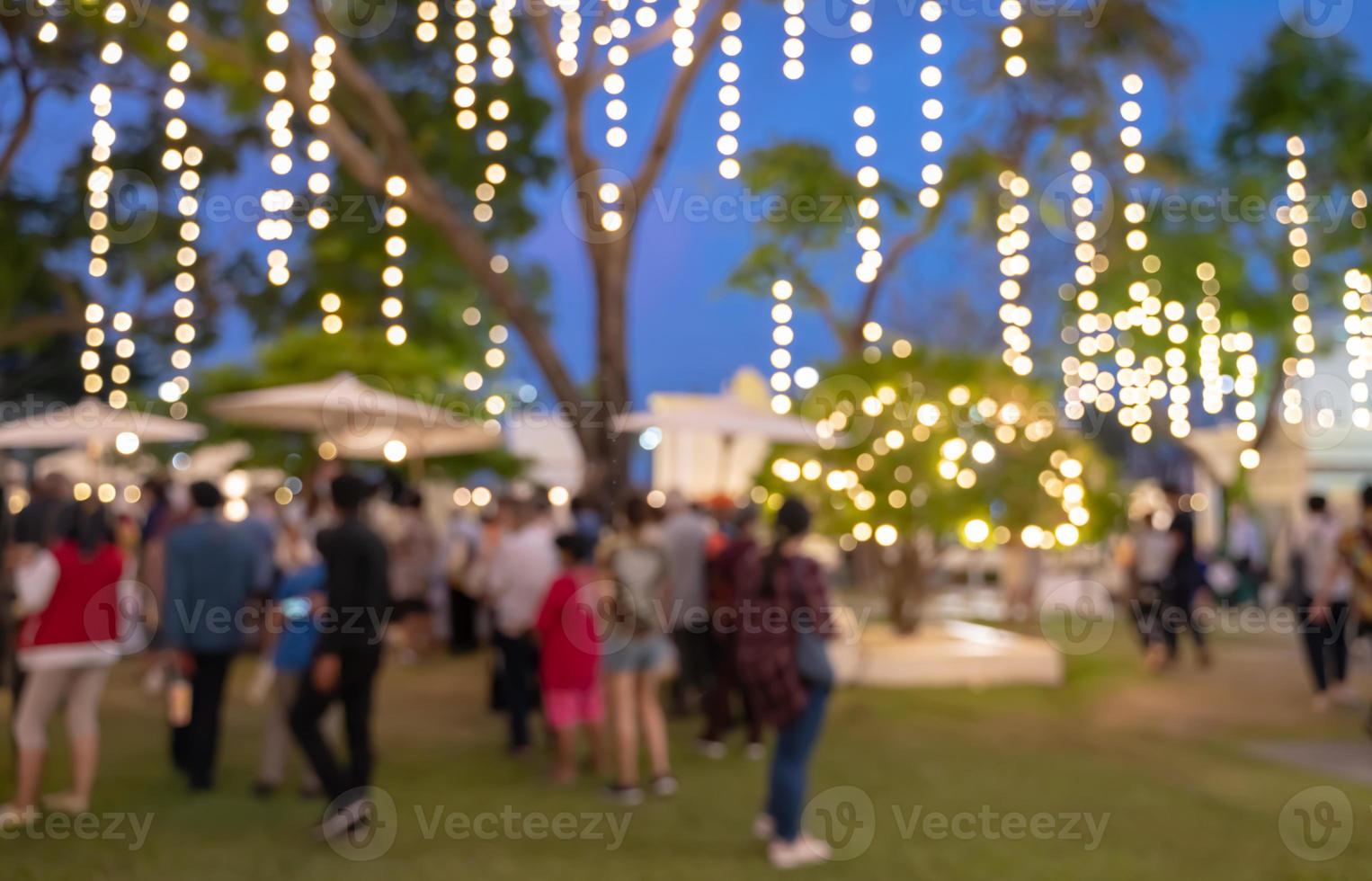 Blur image of night market festival in the park background photo