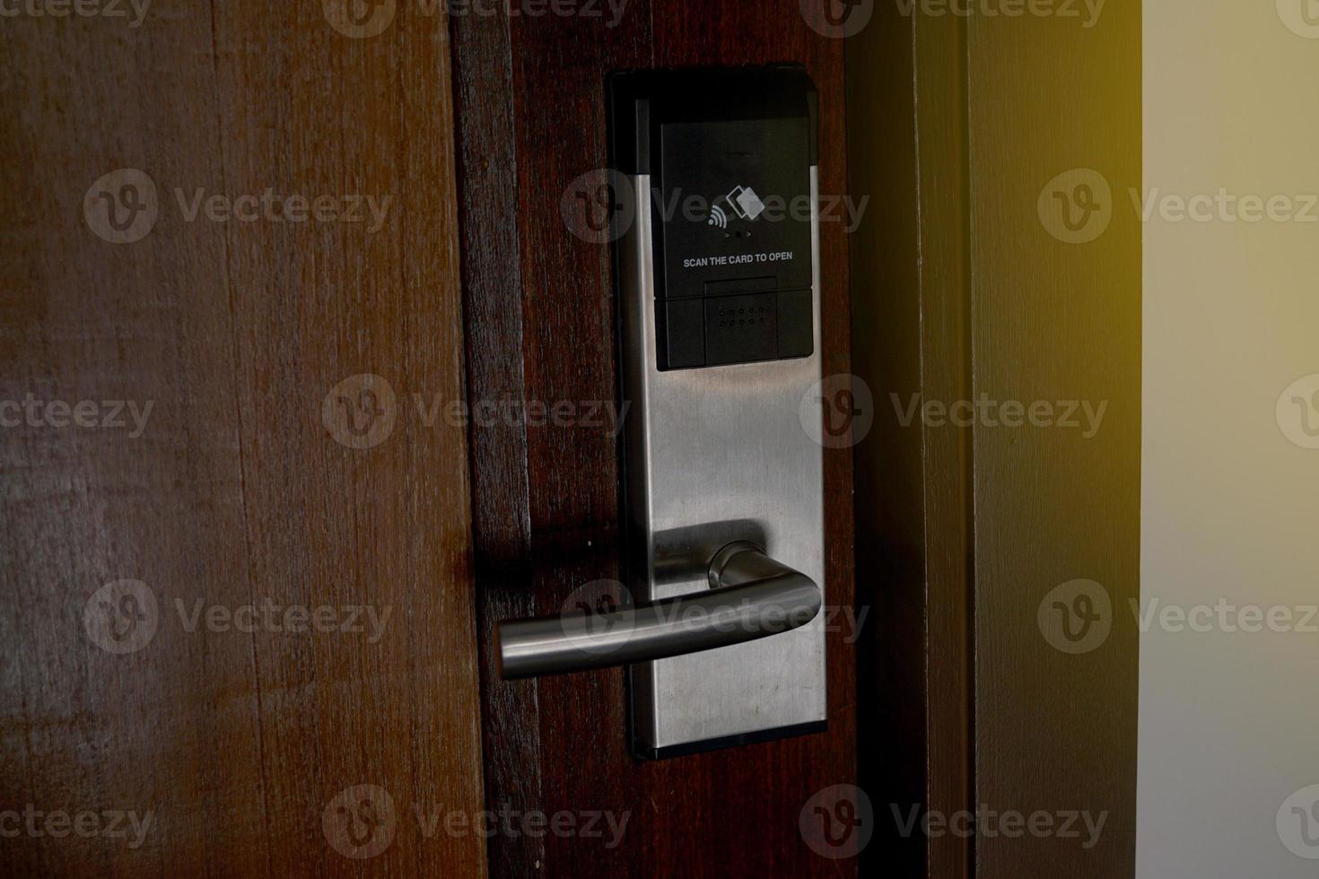 Outside the door that is installed with a key card door lock for hotels or general residences. It is an electronic door lock system that uses a card to open and close the door. photo