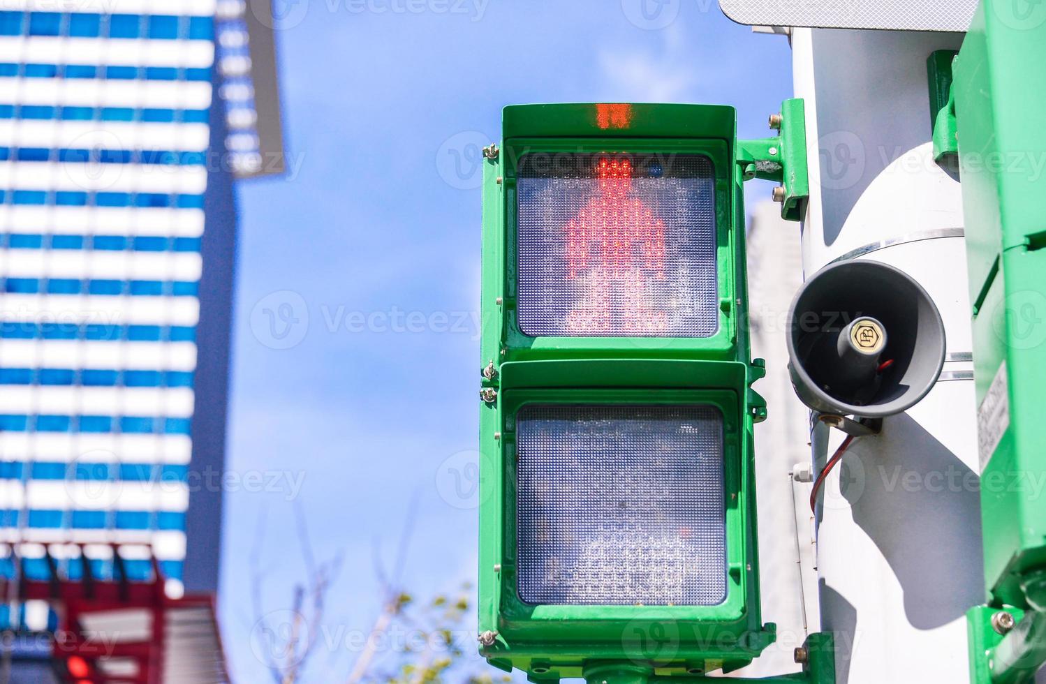 Red traffic light in the city photo