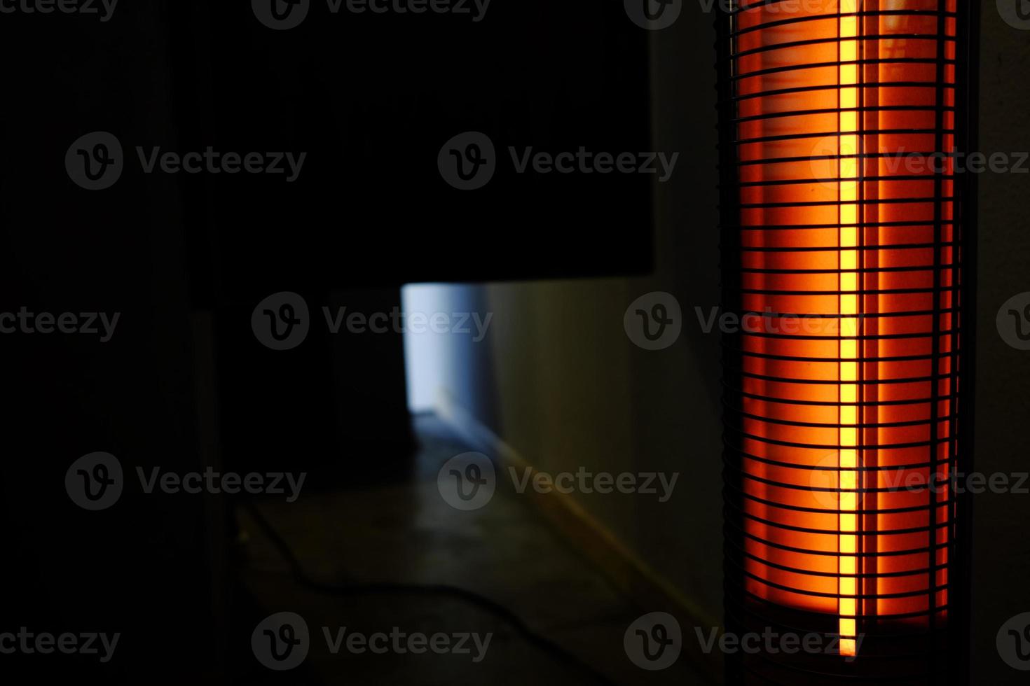 Portable Heater in the Dark Room with Space for Text. photo