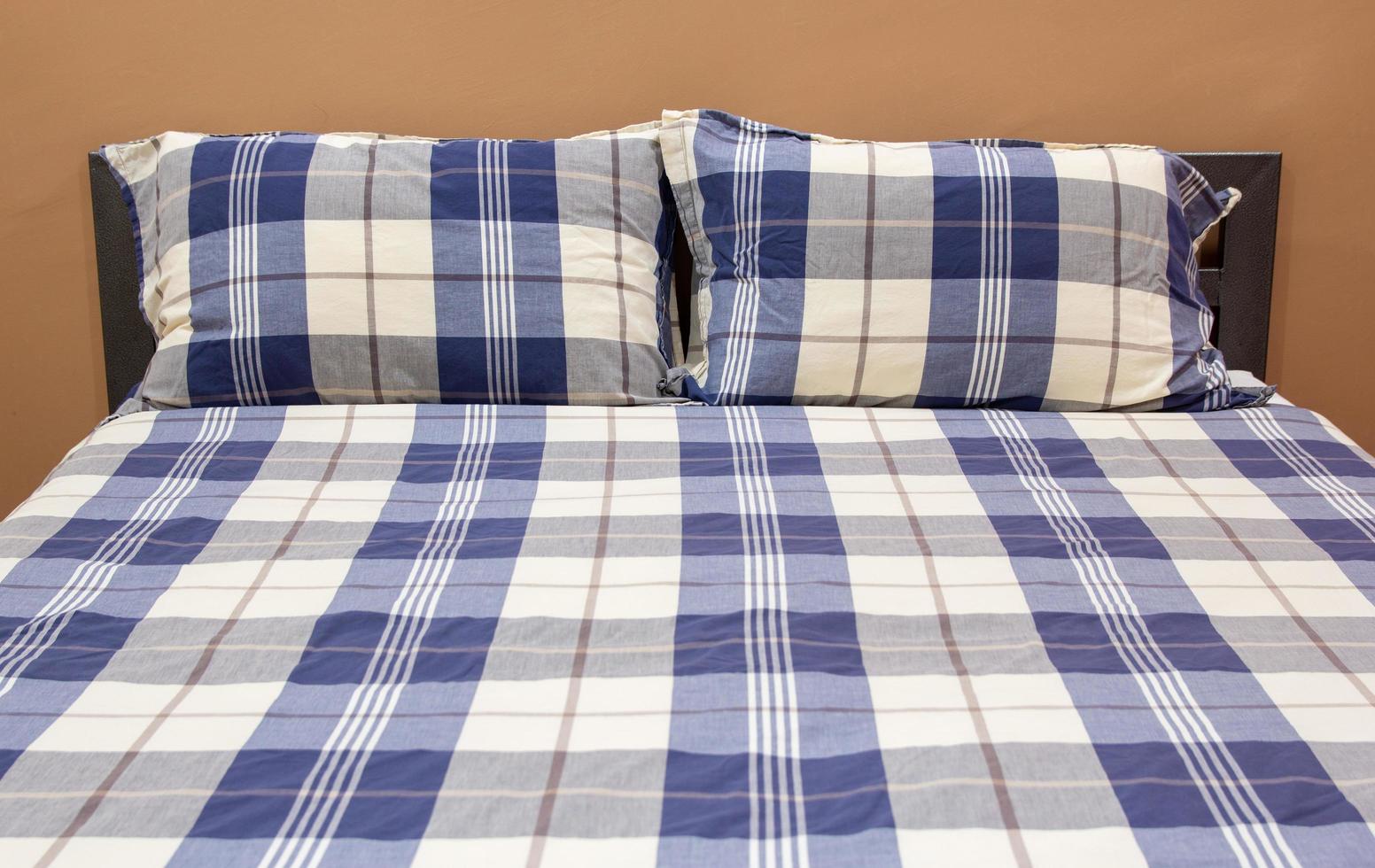 Plaid Bed with Pillow in The Bedroom Interior photo
