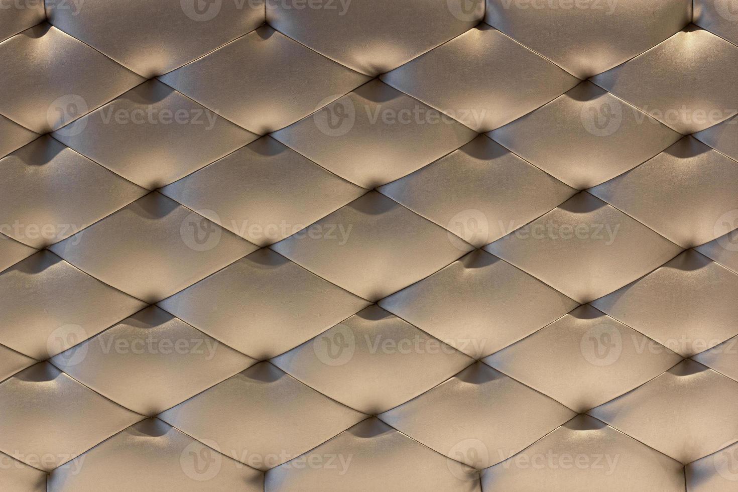 Pattern of Gold Leather Upholstery Sofa Background. Luxury Decoration Sofa photo