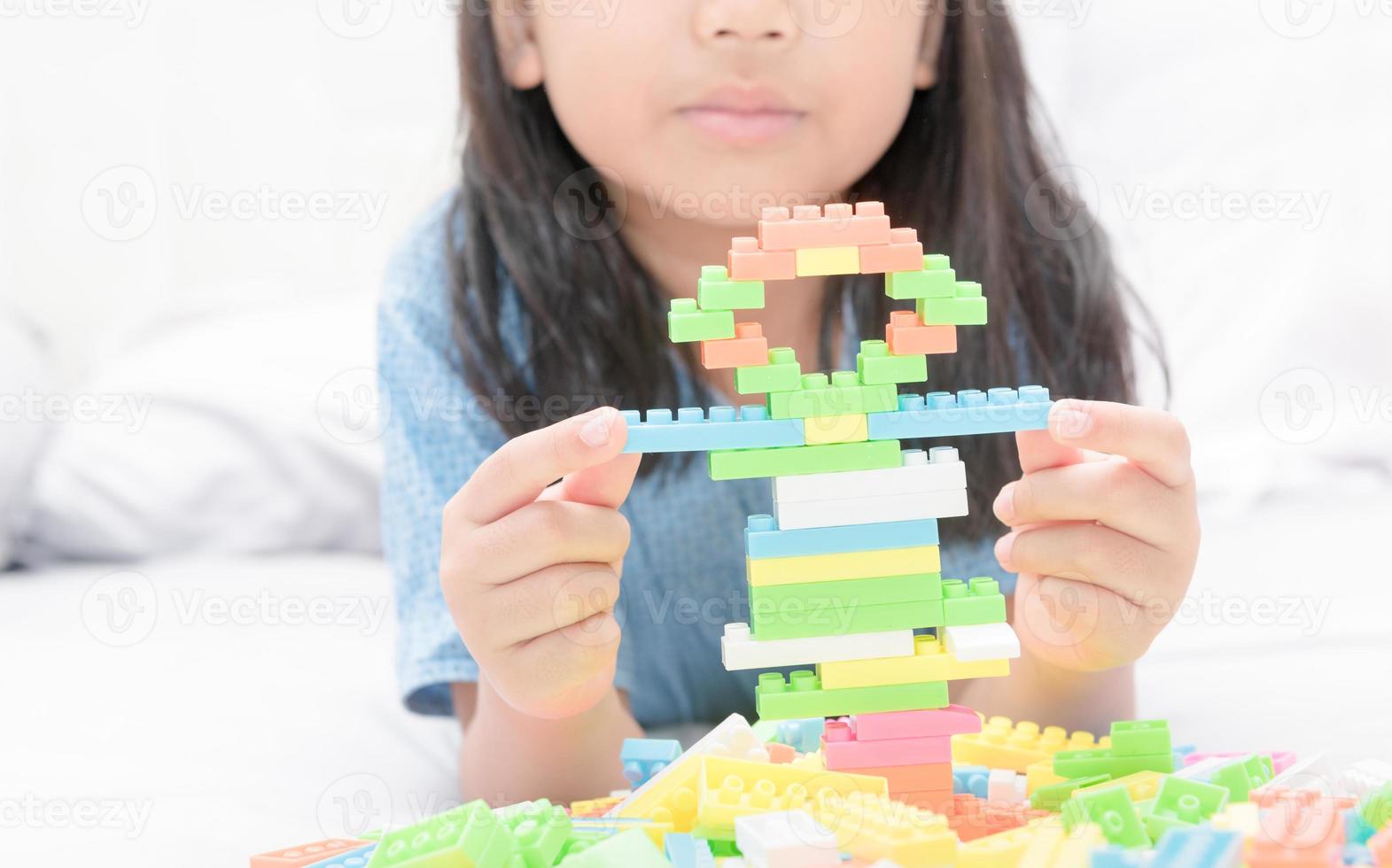 girl play block bricks on bed, education photo