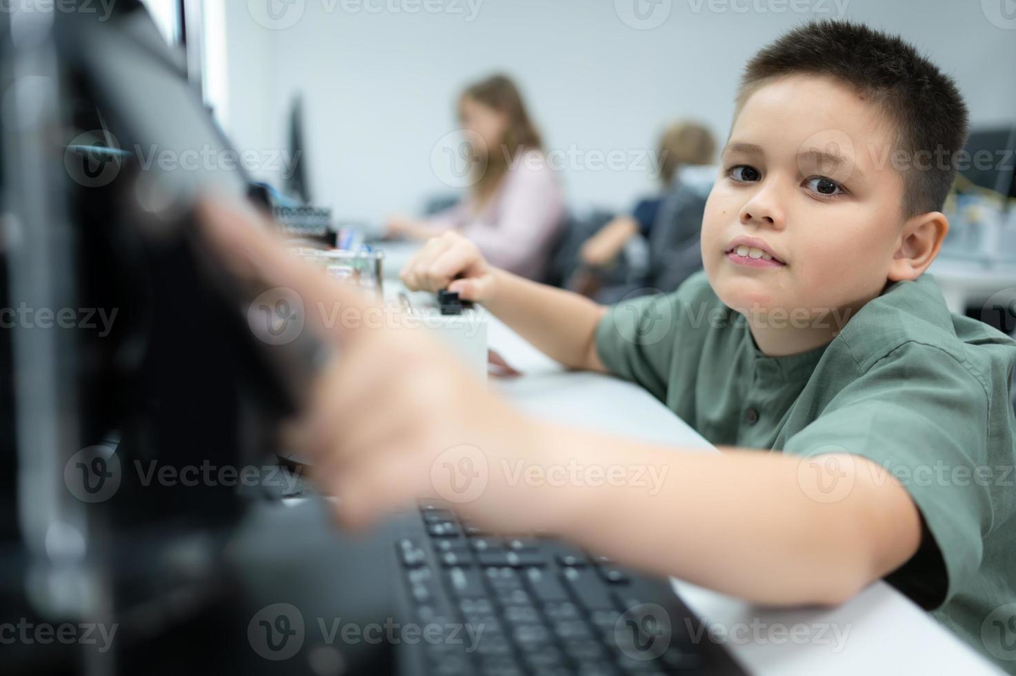 Youngsters utilizing the hand robot technology are having fun learning the electronic circuit board and hand robot controller of robot technology, which is one of the STEM courses. photo