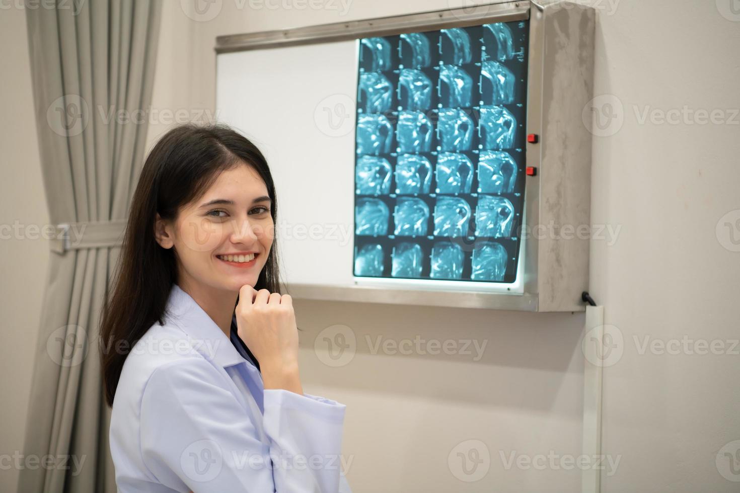 Doctor and patient's x-ray film in hospital examination room photo