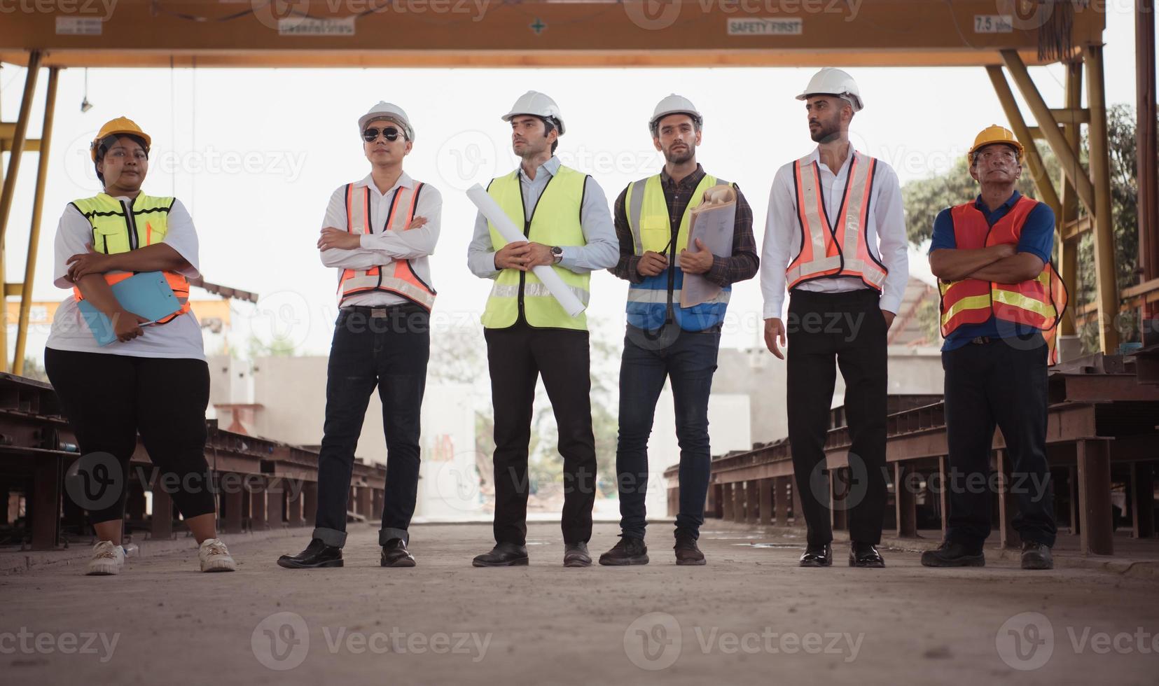 Group of architects, construction foremen, and construction engineers review the work and talk about how the project, in the construction site. photo