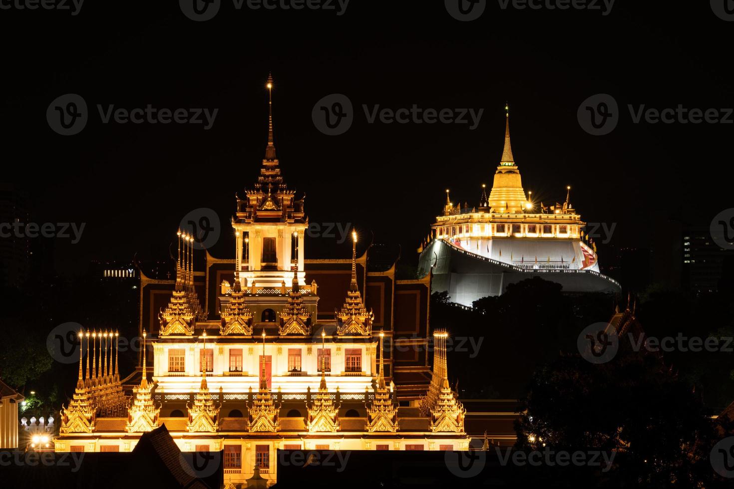 In the dark night, there was still a golden light in the central of Bangkok Thailand, The golden pagoda called the golden mountain temple, Tourist attractions that tourists visit to worship photo