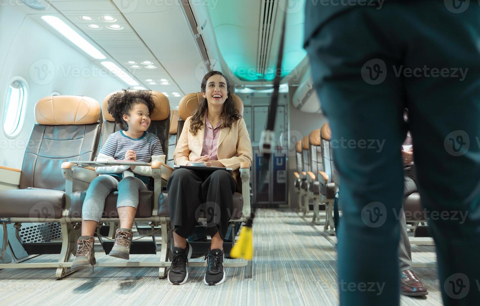 Flight attendants show how to use safety devices and recommend emergency exits. photo