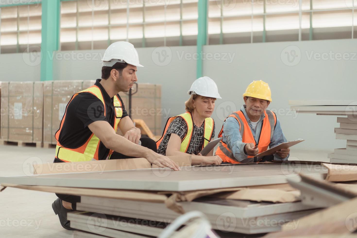 Meeting between designer and warehouse manager to organize the arrangement of product shelves in a huge, empty warehouse and investigating the solar panels that will be installed photo