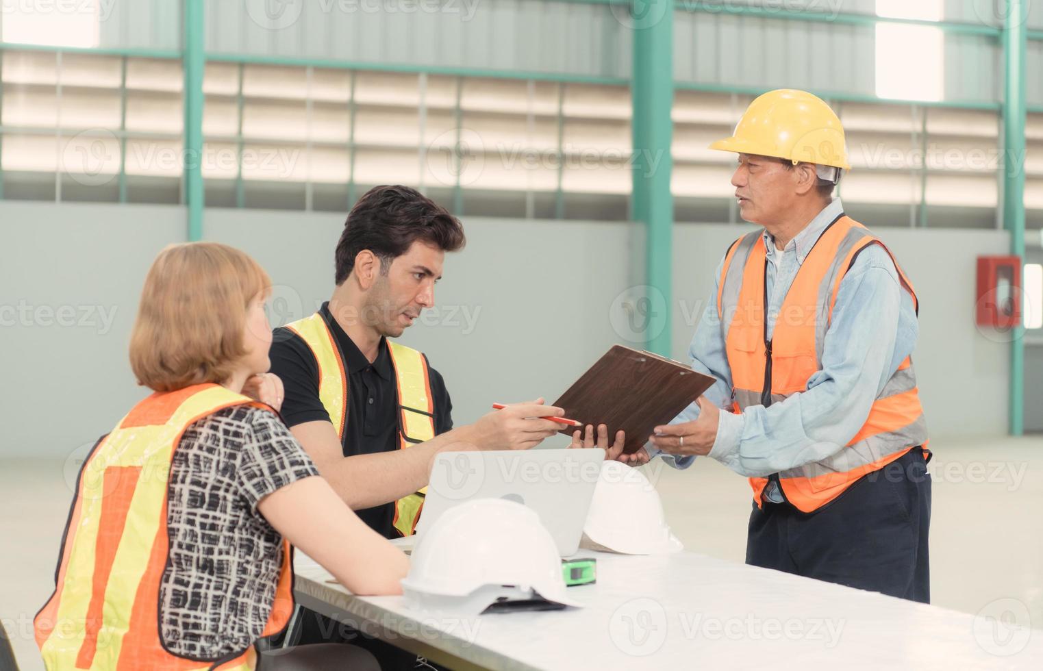 Meeting between designer and warehouse manager to organize the arrangement of product shelves in a huge, empty warehouse. photo