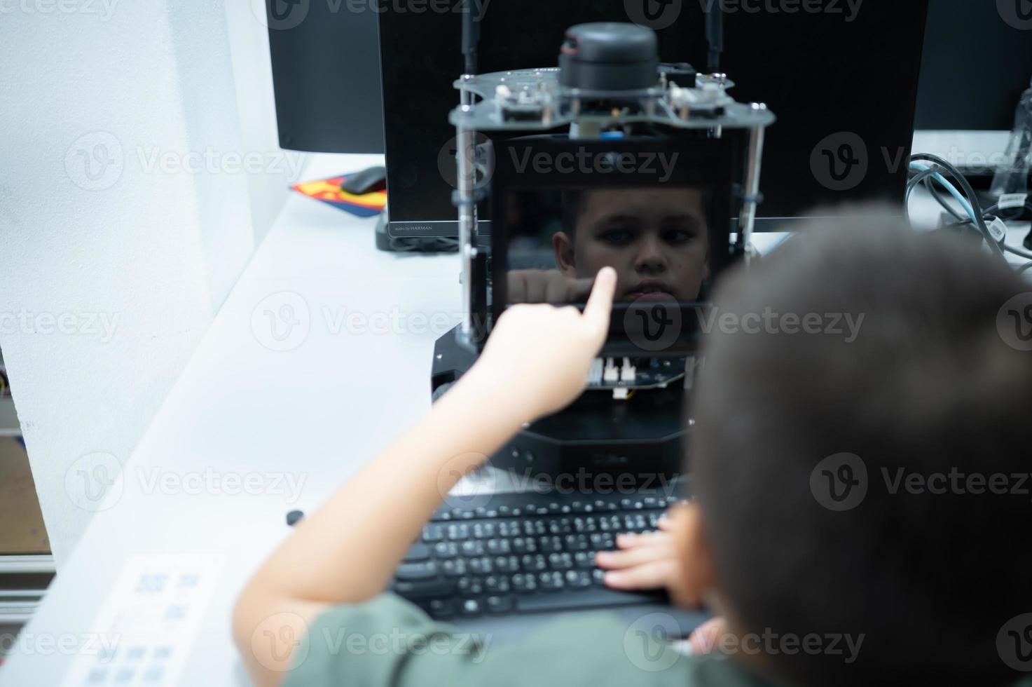 Youngsters utilizing the hand robot technology are having fun learning the electronic circuit board and hand robot controller of robot technology, which is one of the STEM courses. photo