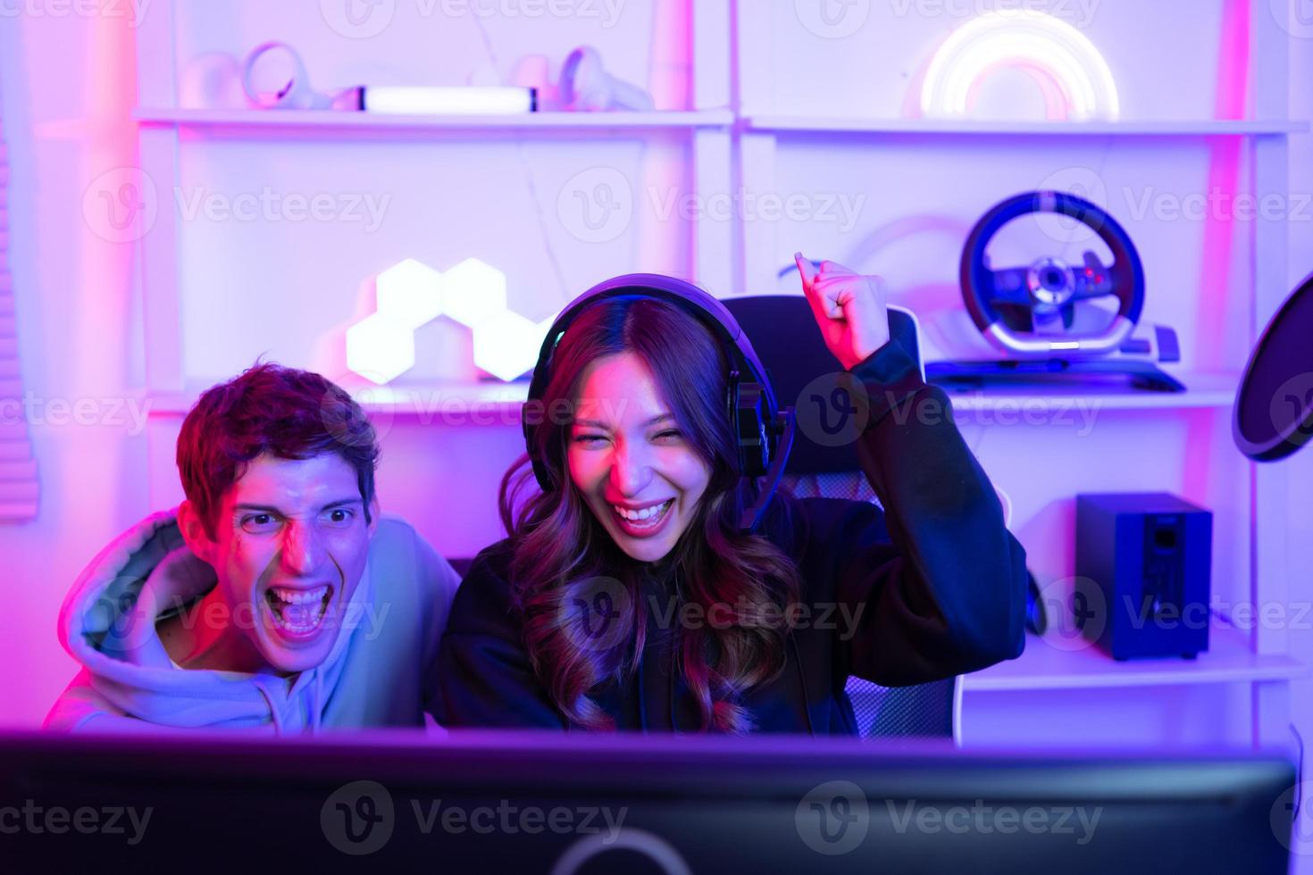Two professional gamers are in a winning mood. That's the thrill of victory. photo