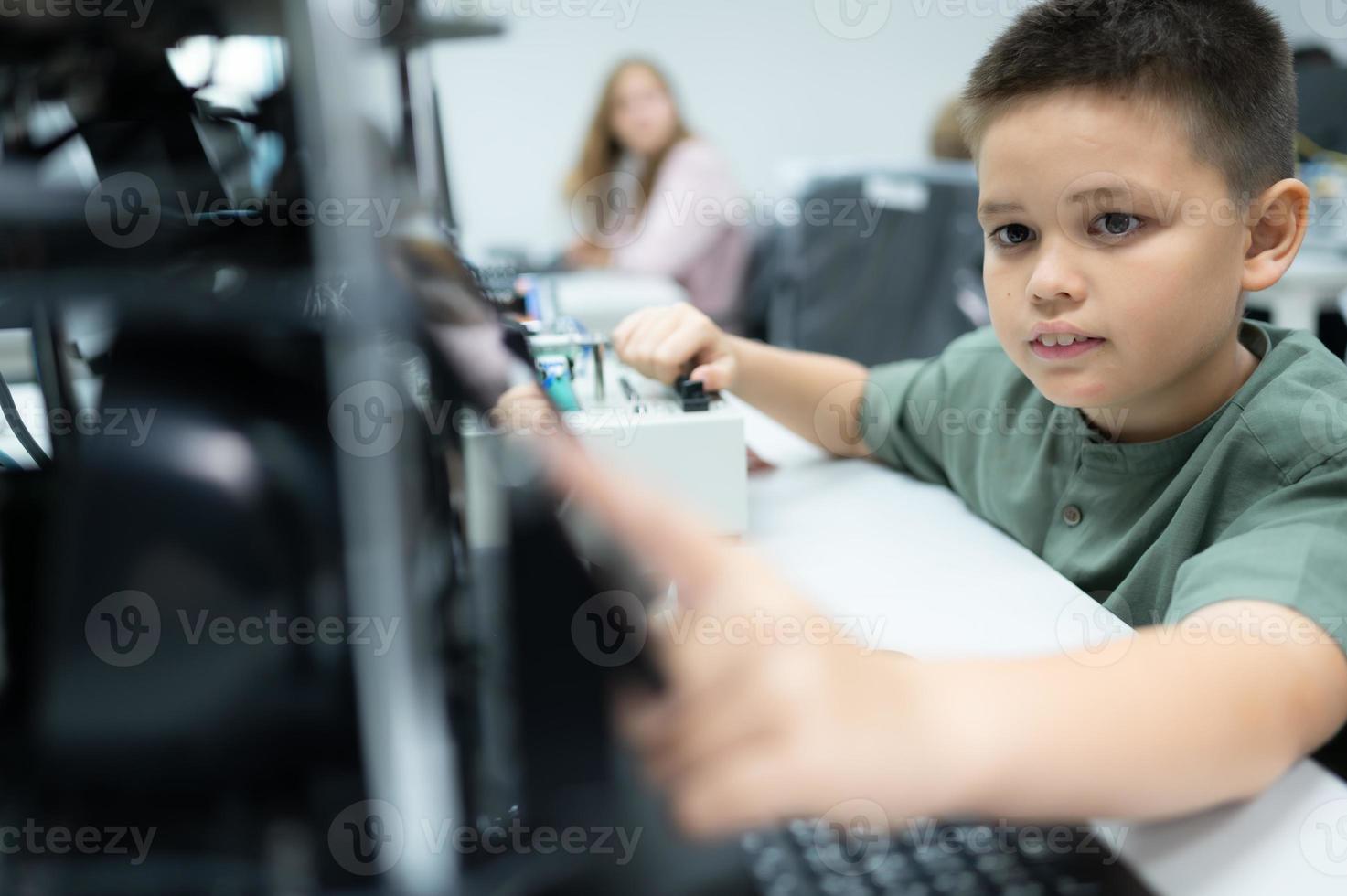 Youngsters utilizing the hand robot technology are having fun learning the electronic circuit board and hand robot controller of robot technology, which is one of the STEM courses. photo