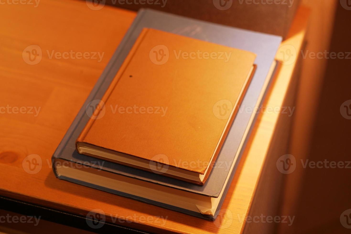 stack of books on wooden table photo