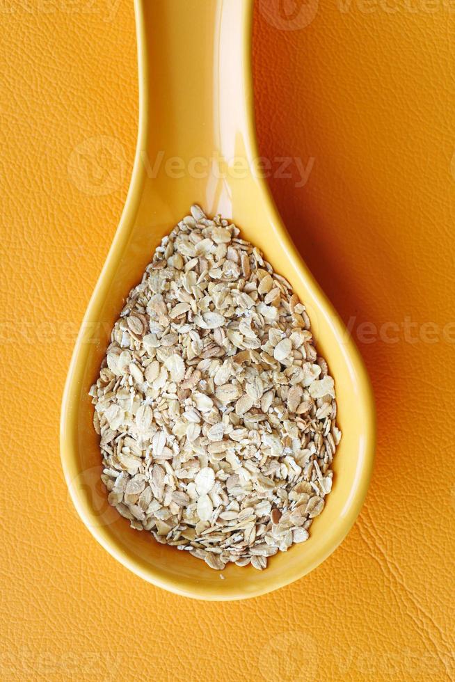 roasted oats flakes spilling on table photo