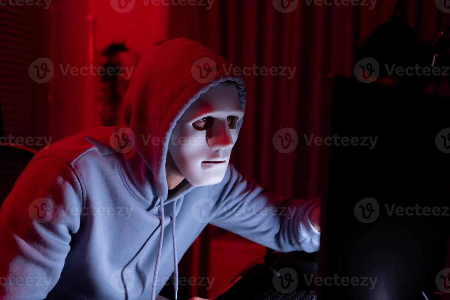 This is the face of a hacker who is knowledgeable with operating systems and other programs. He will exploit flaws and breach the computer system to cause damage. photo