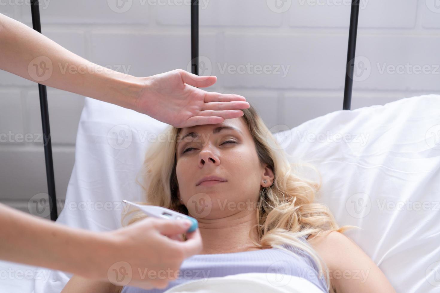 LGBT Young couple taking care of each other in times of illness, Checking your temperature to ensure that are not seriously ill. photo